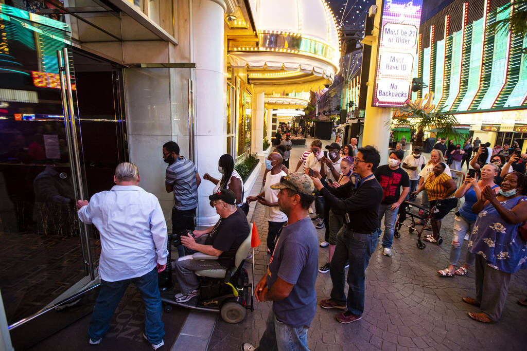 People enter the Golden Nugget at 12:01 a.m. as hotel-casinos reopen in downtown Las Vegas on T ...