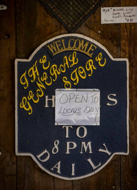 A sign on the door of The General Store notes they are "Open to locals only" in Goldfield on Tu ...