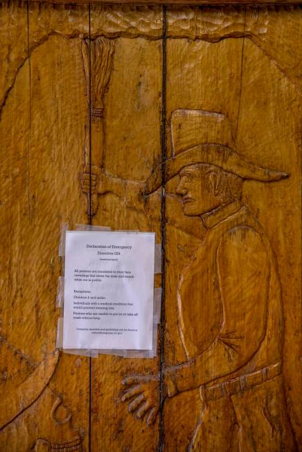 A carved wooden door by owner Bryan Smalley of the Hidden Treasure Trading Co. displays a face ...