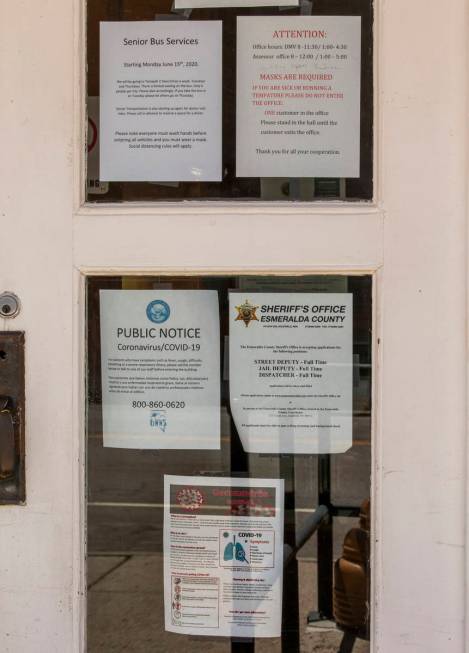Numerous COVID-19 notices are taped to the front windows at the Esmeralda County Courthouse on ...