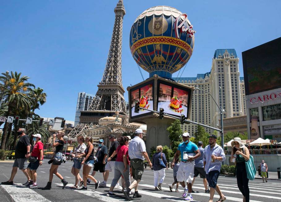 Tourists cross Las Vegas Boulevard near Paris Las Vegas, July 3, 2020. (Bizuayehu Tesfaye/Las V ...