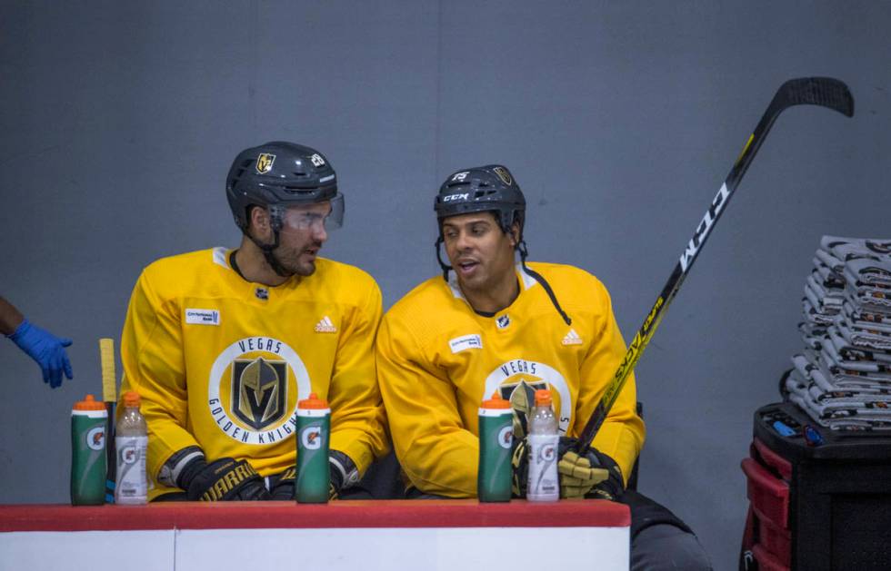 Vegas Golden Knights left wing William Carrier (28, left) and right wing Ryan Reaves (75) talk ...