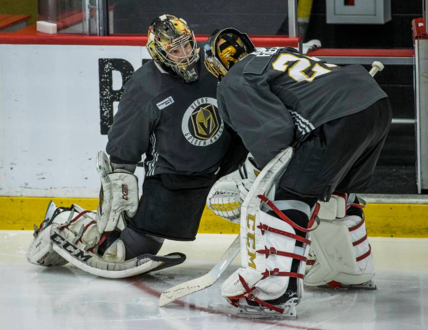 Vegas Golden Knights goaltender Marc-Andre Fleury (29, right) chats with goaltender Oscar Dansk ...