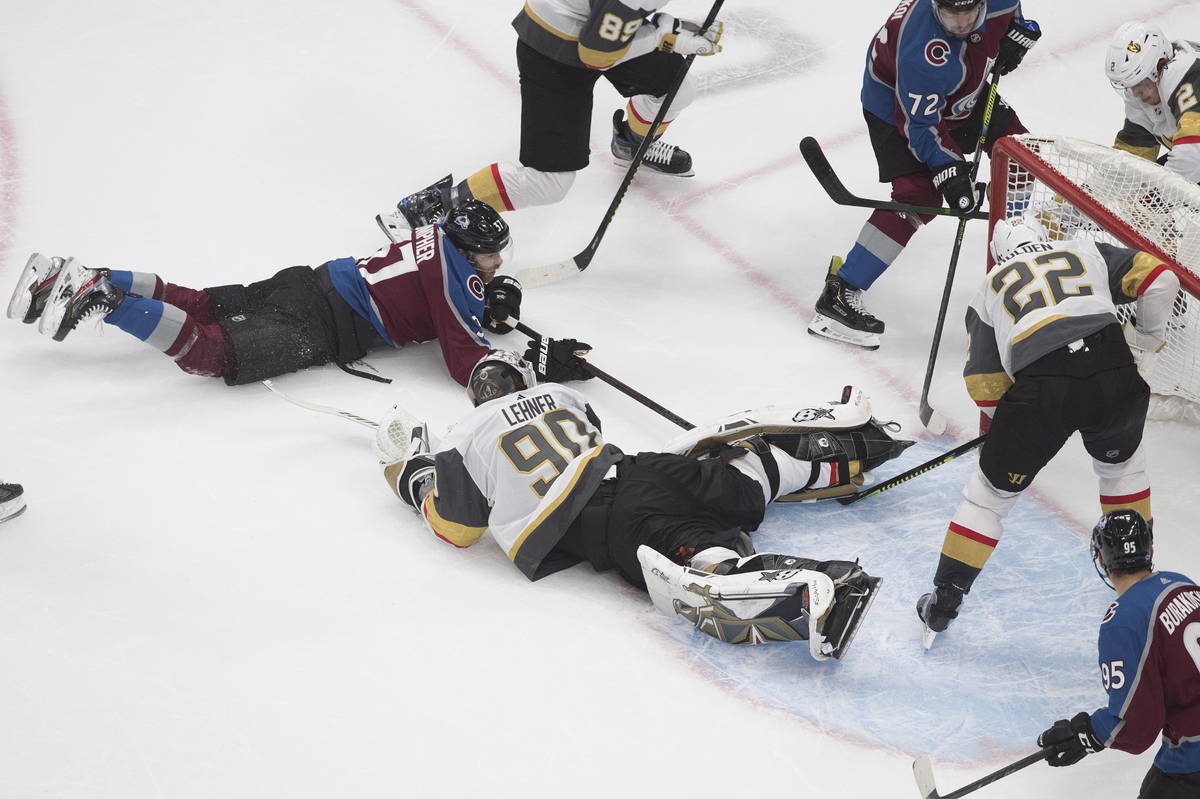 Colorado Avalanche's J.T. Compher (37), left, scores on Vegas Golden Knights goalie Robin Lehne ...