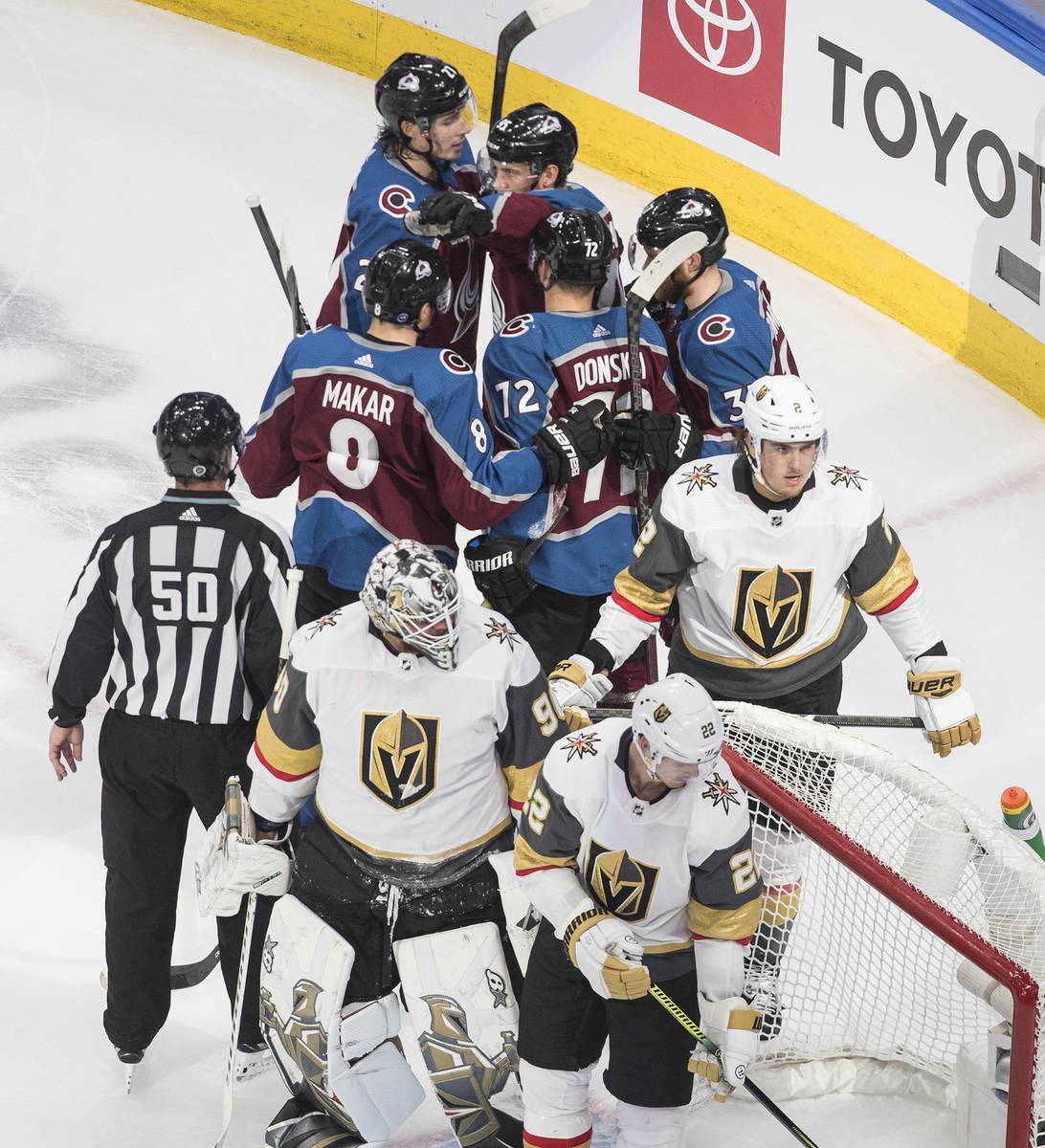 Colorado Avalanche players, rear, celebrate a goal during the second period of an NHL hockey qu ...