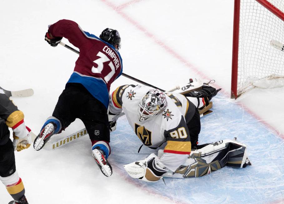 Colorado Avalanche's J.T. Compher (37) scores on Vegas Golden Knights goalie Robin Lehner (90) ...