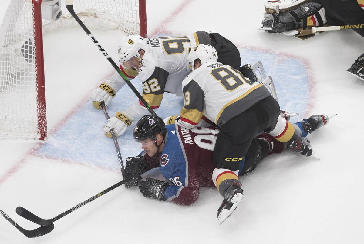 Colorado Avalanche's Mikko Rantanen (96) is taken down by Vegas Golden Knights' Tomas Nosek (92 ...