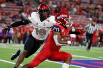 UNLV linebacker Javin White tries to stop Fresno State running back Ronnie Rivers during the fi ...