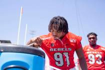 UNLV's defensive line Nate Neal (91) hydrates during the team's photo day at Sam Boyd Stadium i ...