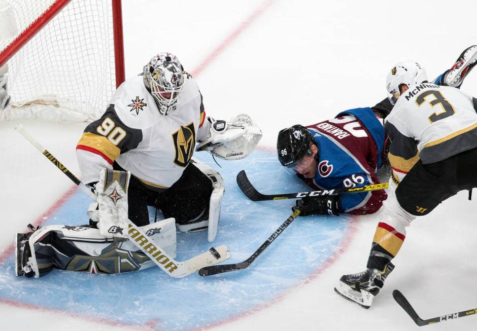 Colorado Avalanche's Mikko Rantanen (96) tries to get the puck past Vegas Golden Knights goalie ...