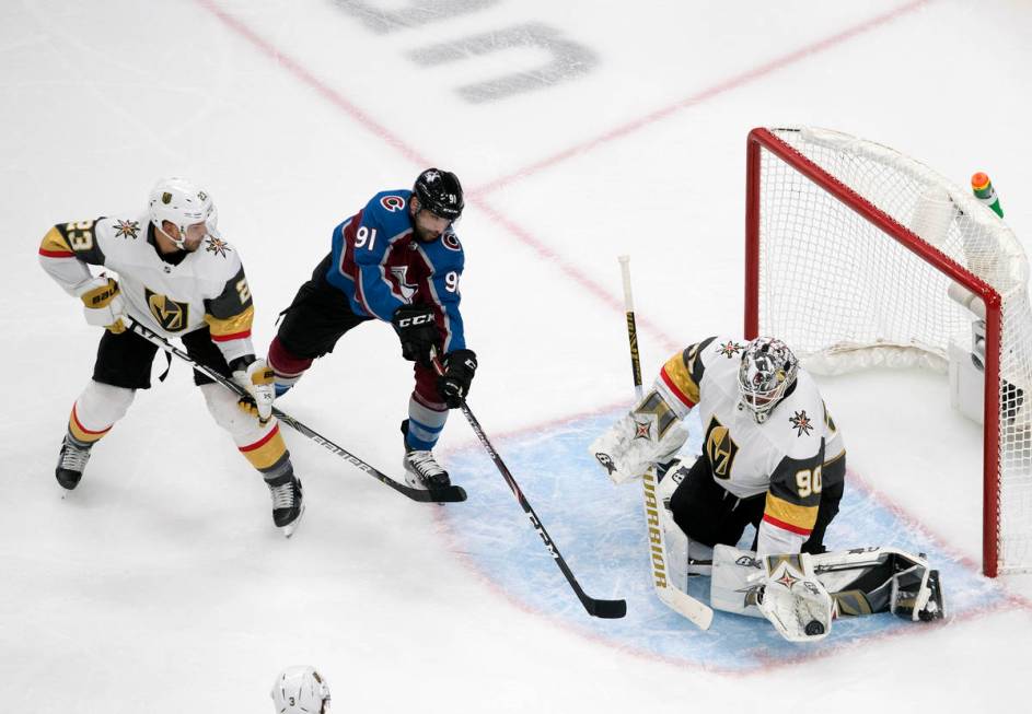 Colorado Avalanche's Nazem Kadri (91) is stopped by Vegas Golden Knights goalie Robin Lehner (9 ...