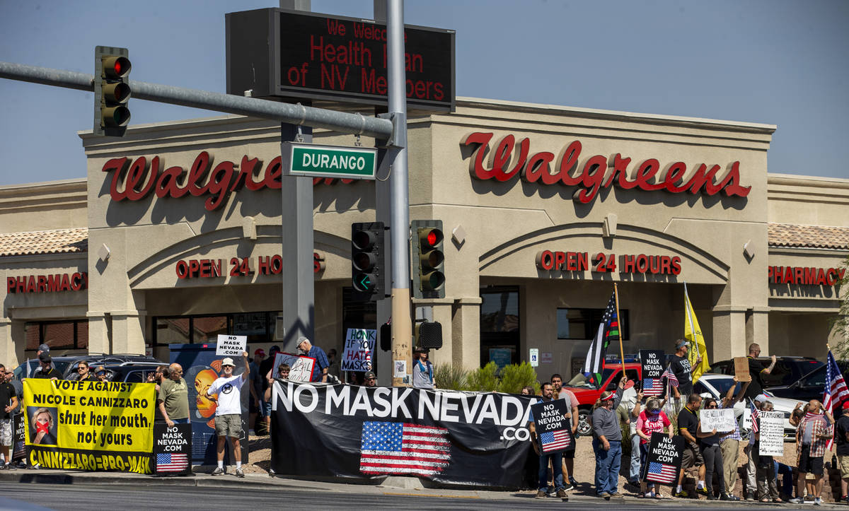 Supporters line the sidewalks during a No Mask Nevada rally to oppose the face mask mandate and ...