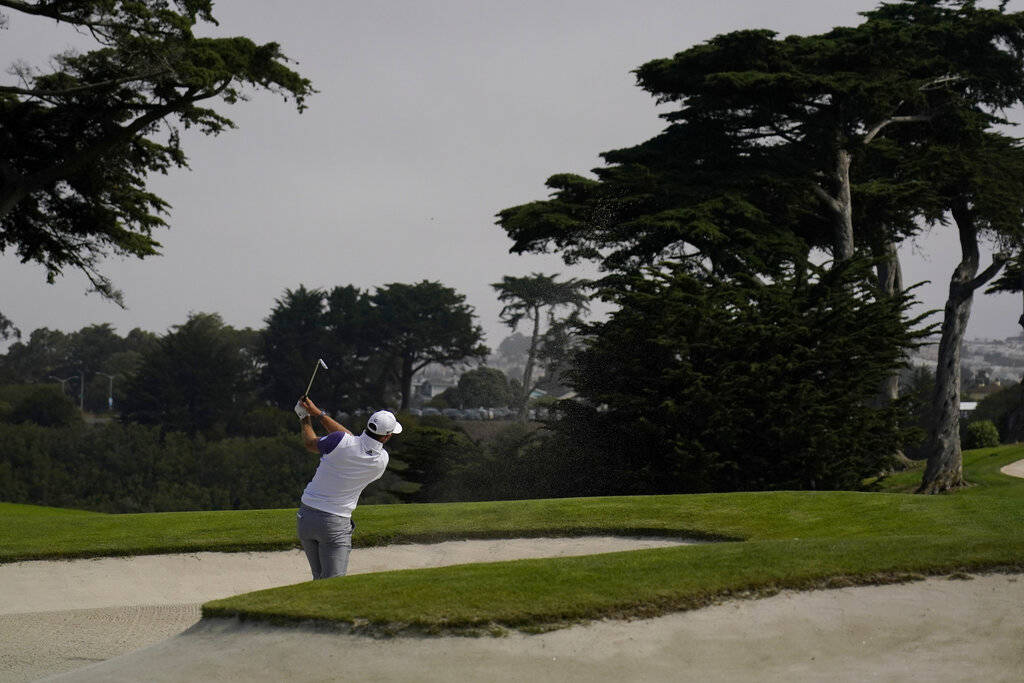 Dustin Johnson hits from the bunker on the 18th hole during the first round of the PGA Champion ...