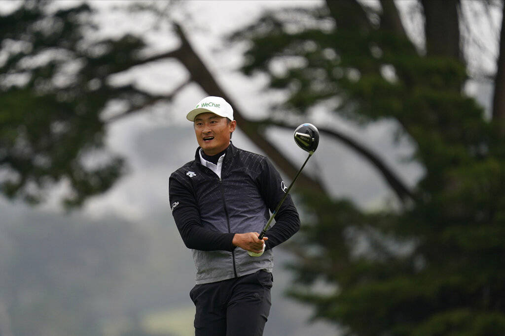 Li Haotong of China, watches his tee shot on the fourth hole during the third round of the PGA ...