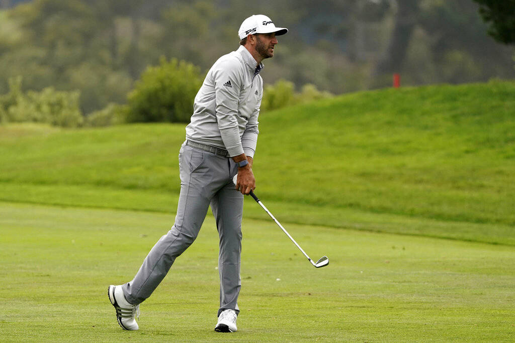 Dustin Johnson hits from the fairway on the 18th hole during the third round of the PGA Champio ...