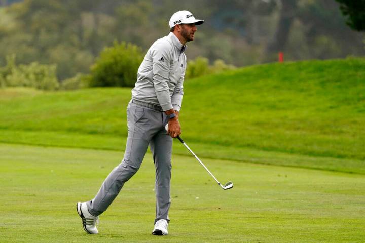 Dustin Johnson hits from the fairway on the 18th hole during the third round of the PGA Champio ...