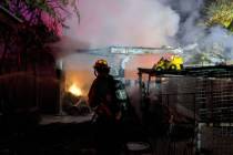Crews battle a shed fire Sunday, Aug. 9, 2020, on the 3400 block of Navajo Way in Las Vegas. (L ...