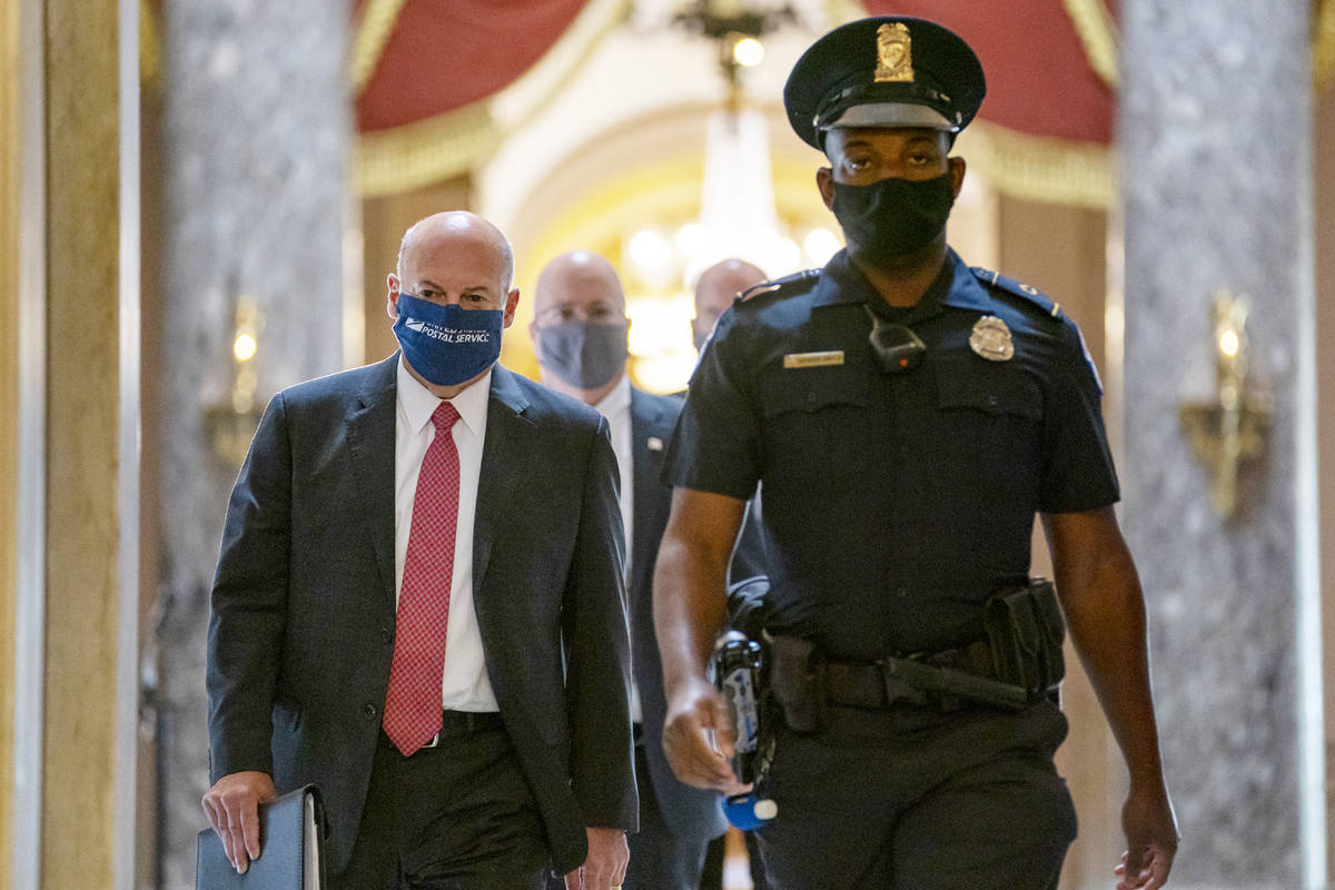 Postmaster General Louis DeJoy, left, is escorted to House Speaker Nancy Pelosi's office on Cap ...