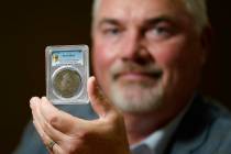 Bruce Morelan poses for a portrait holding a rare 1794 U.S. silver dollar, said to be among the ...