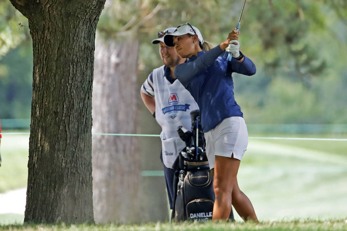 Danielle Kang hits from under a tree on the fifth fairway during the final round of the Maratho ...