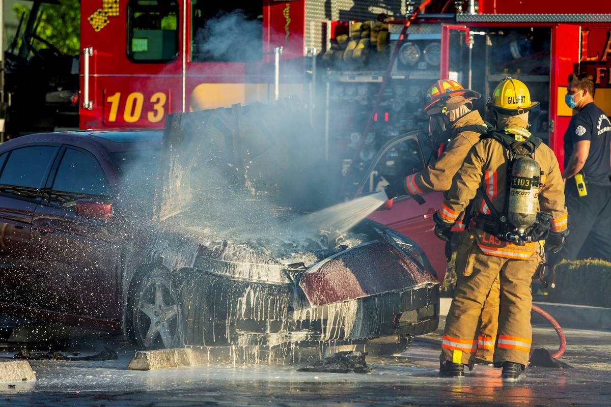 Las Vegas Firefighters extinguish a car fire in the Mariana's Supermarkets parking lot at 100 N ...