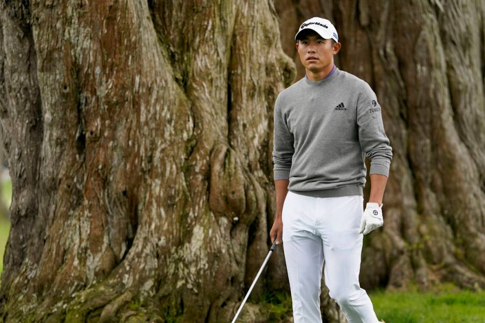 Collin Morikawa checks his shot from the tress on the sixth hole during the final round of the ...