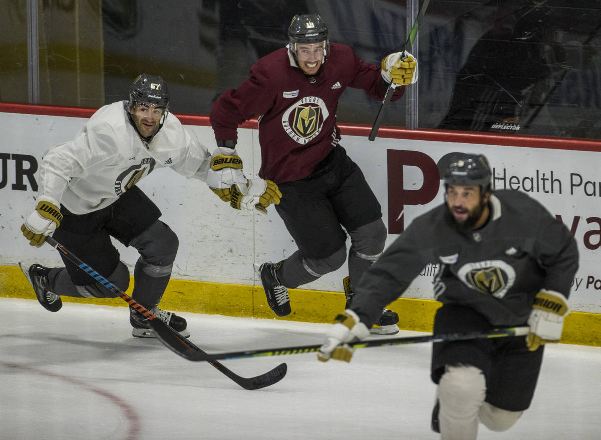 Vegas Golden Knights left wing Max Pacioretty (67, left) races to the puck with right wing Reil ...