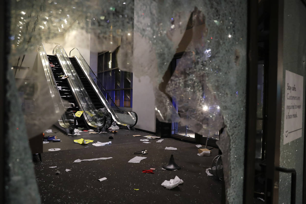 Glass is shattered in the Nordstrom store after a riot occurred in the Gold Coast area of the c ...