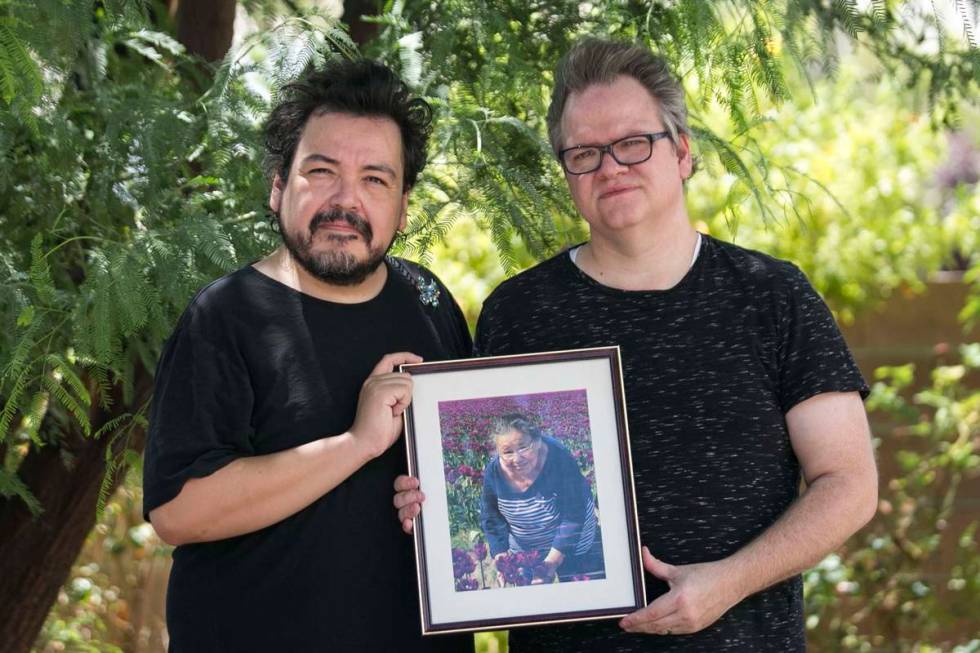 Isaias Urrabazo, left, and his husband, Steven Fehr, hold a photo of Maria Urrabazo, Isaias&#x2 ...