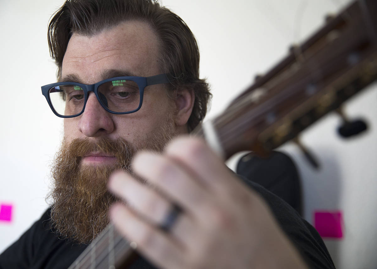 Paul Kleemann, a guitar director at Del Sol Academy, plays guitar at his home in Las Vegas in L ...