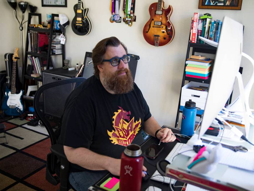 Paul Kleemann, a guitar director at Del Sol Academy, works on his computer at his home in Las V ...