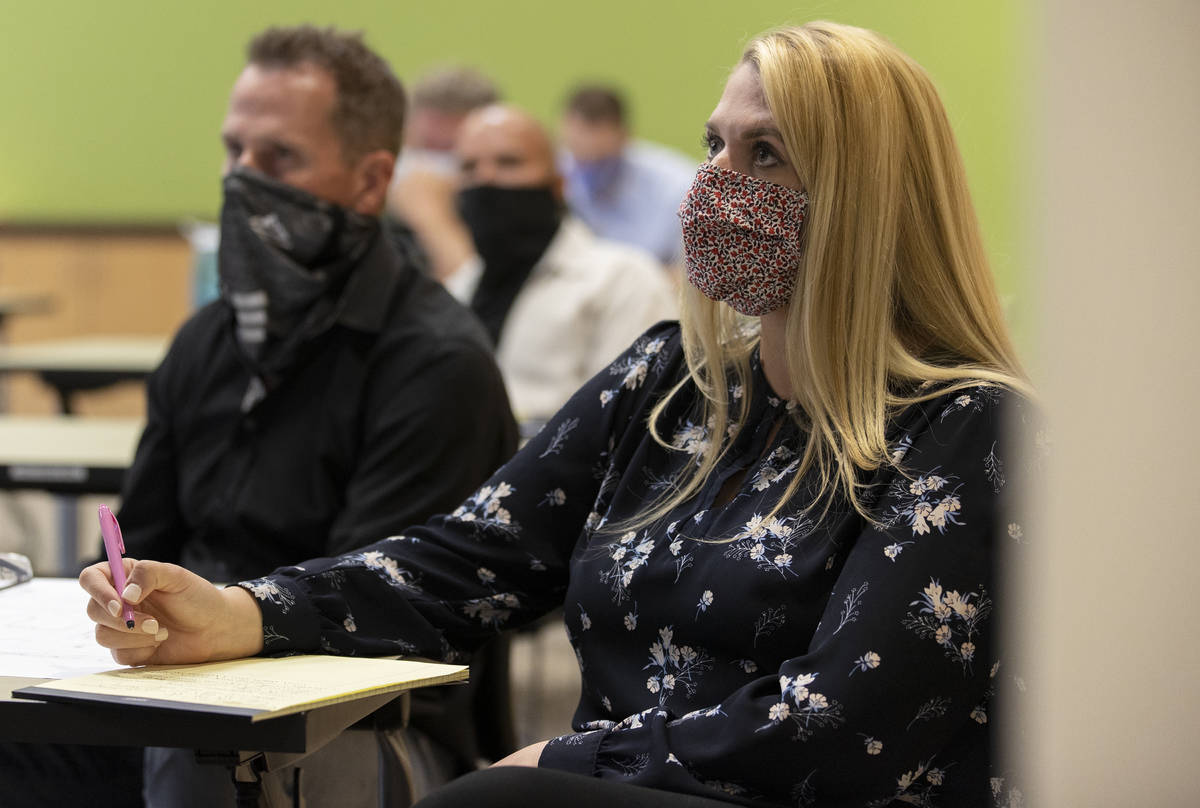 Elisabeth Olson, an associate with Kaempfer Crowell, listens to a speaker during a "Live & ...