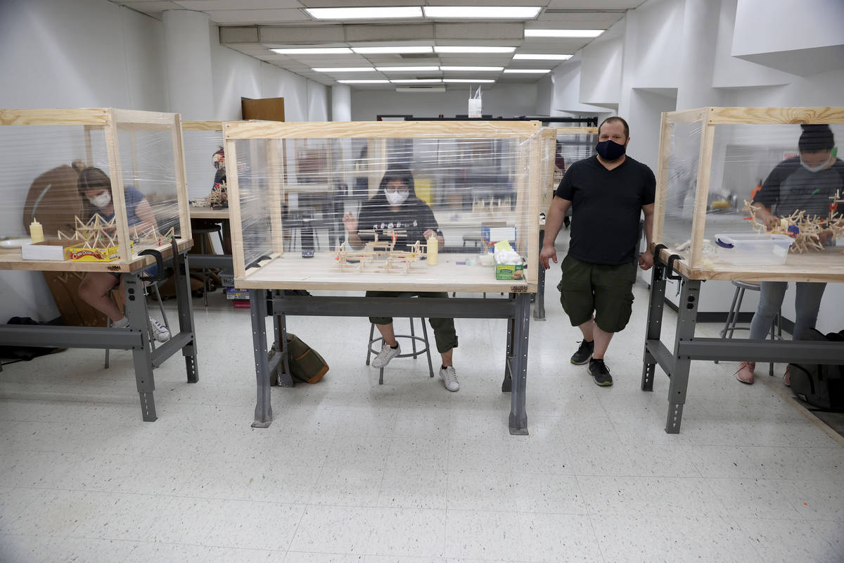 Dave Rowe, associate professor of sculpture practices, walks the classroom during an art class ...