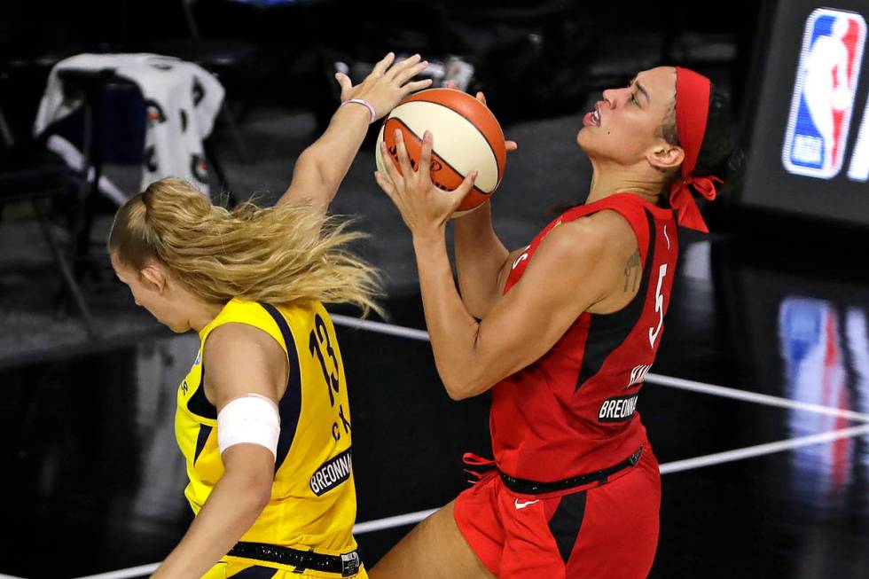 Las Vegas Aces forward Dearica Hamby (5) scores in front of Indiana Fever forward Lauren Cox (1 ...