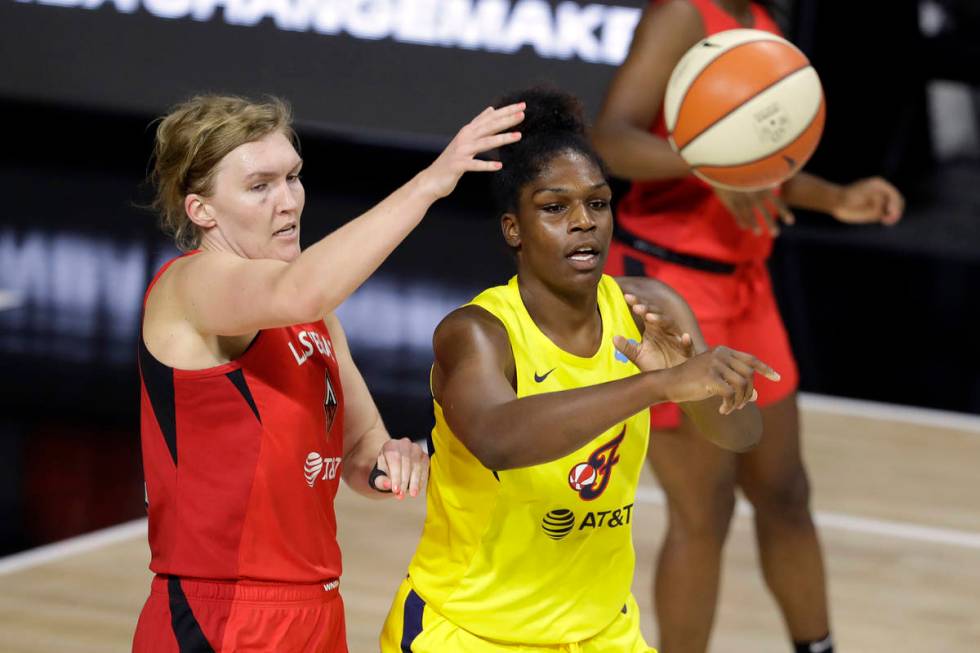 Indiana Fever center Teaira McCowan (15) pases the ball in front of Las Vegas Aces center Carol ...
