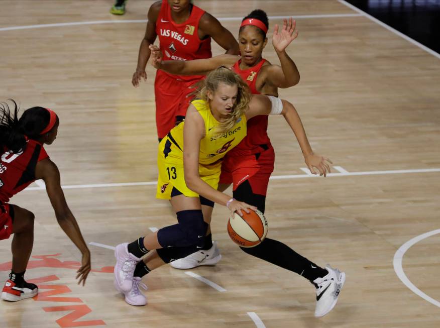 Indiana Fever forward Lauren Cox (13) drives around Las Vegas Aces center A'ja Wilson (22) duri ...