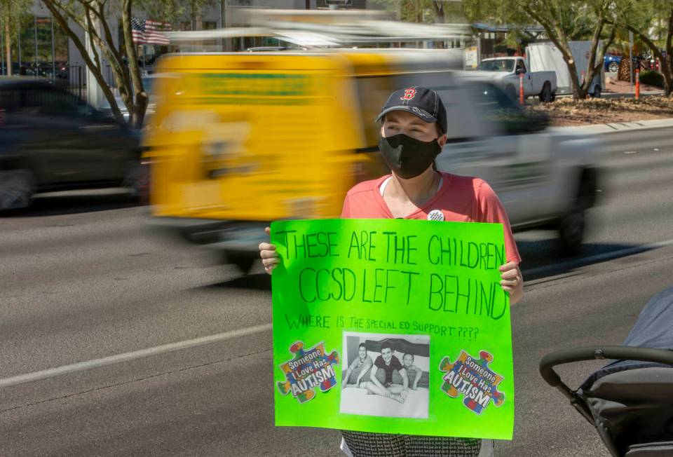 Parent and advocate Diana Battista holds a sign outside the Clark County School District Admini ...