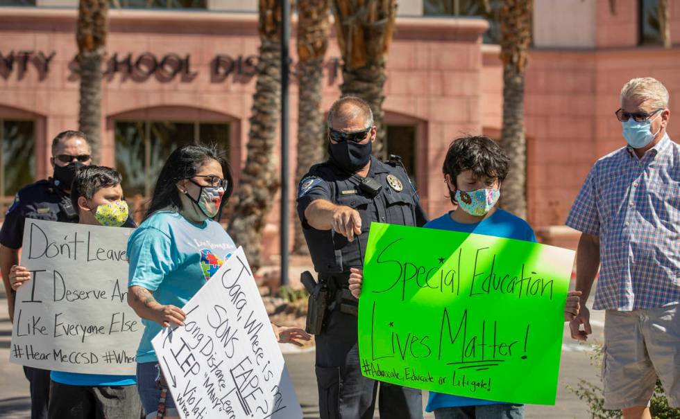 Clark County School District officers direct parents and students off the administration center ...