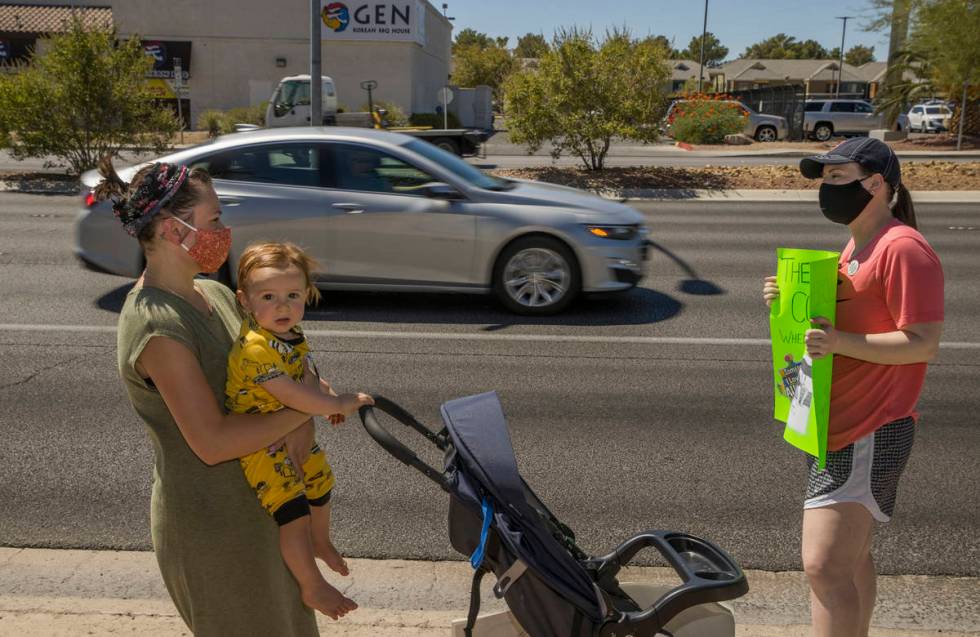 Esther Johnson, left, with son Eli Yosef, 1, stand with Diana Battista outside the County Schoo ...