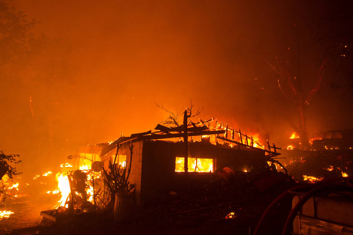 A home is consumed by flames in the Lake Hughes fire in Angeles National Forest on Wednesday, A ...