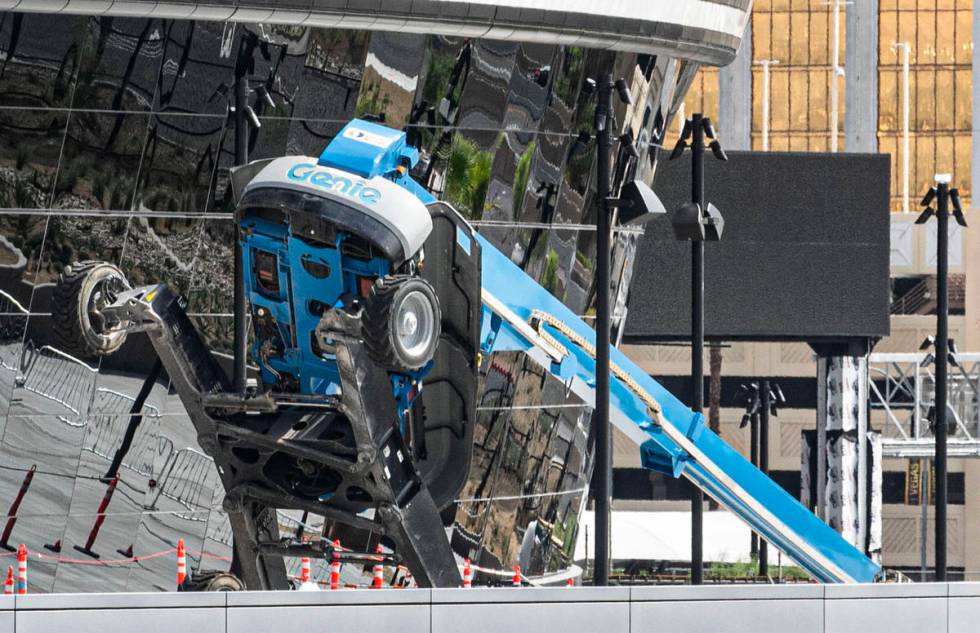 A boom lift lays on its side on the exterior of Allegiant Stadium in Las Vegas on Thursday, Aug ...