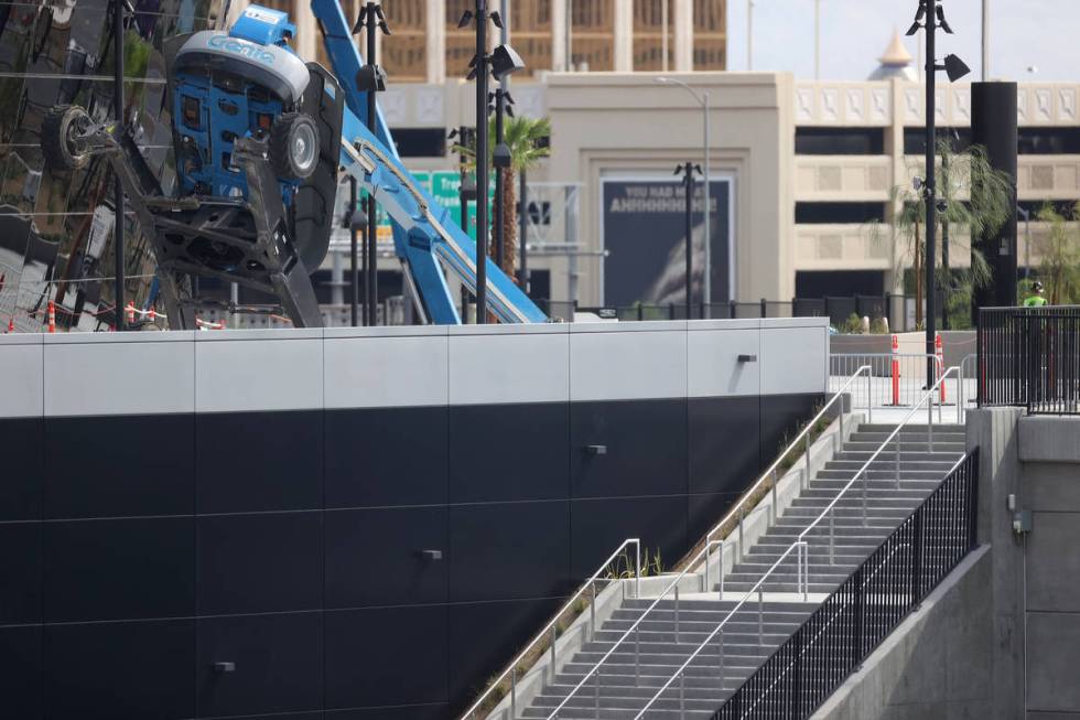 A boom lift lays on its side on the exterior of Allegiant Stadium in Las Vegas, Thursday, Aug. ...