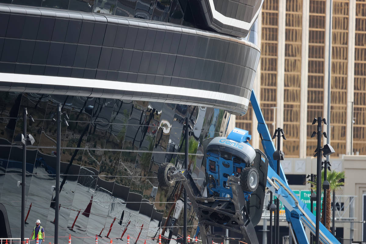 A boom lift lays on its side on the exterior of Allegiant Stadium in Las Vegas, Thursday, Aug. ...