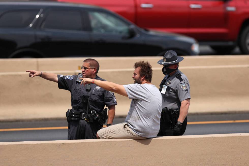 Nevada Highway Patrol officers interview a man after a fatal two-vehicle crash on northbound In ...