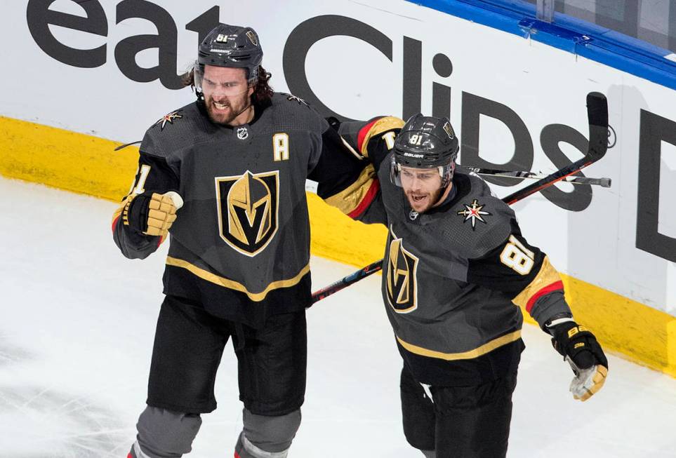 Vegas Golden Knights' Mark Stone (61) and Jonathan Marchessault (81) celebrate a goal against t ...