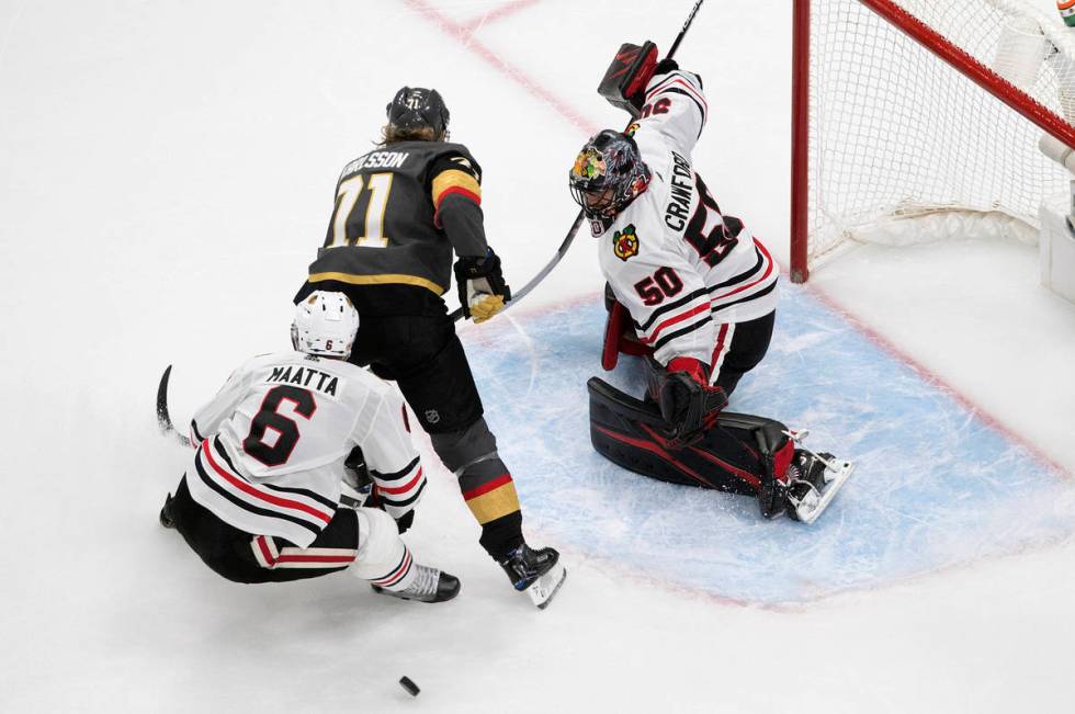 Vegas Golden Knights' William Karlsson (71) is stopped by Chicago Blackhawks goalie Corey Crawf ...