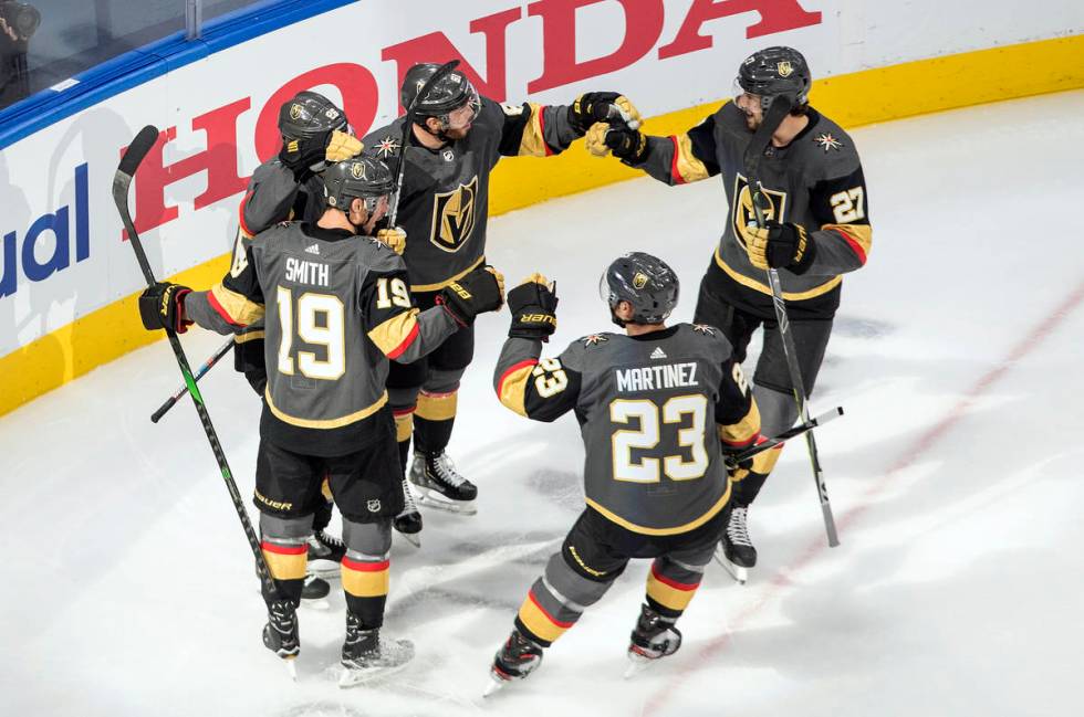 Vegas Golden Knights players celebrate a goal against the Chicago Blackhawks during the first p ...