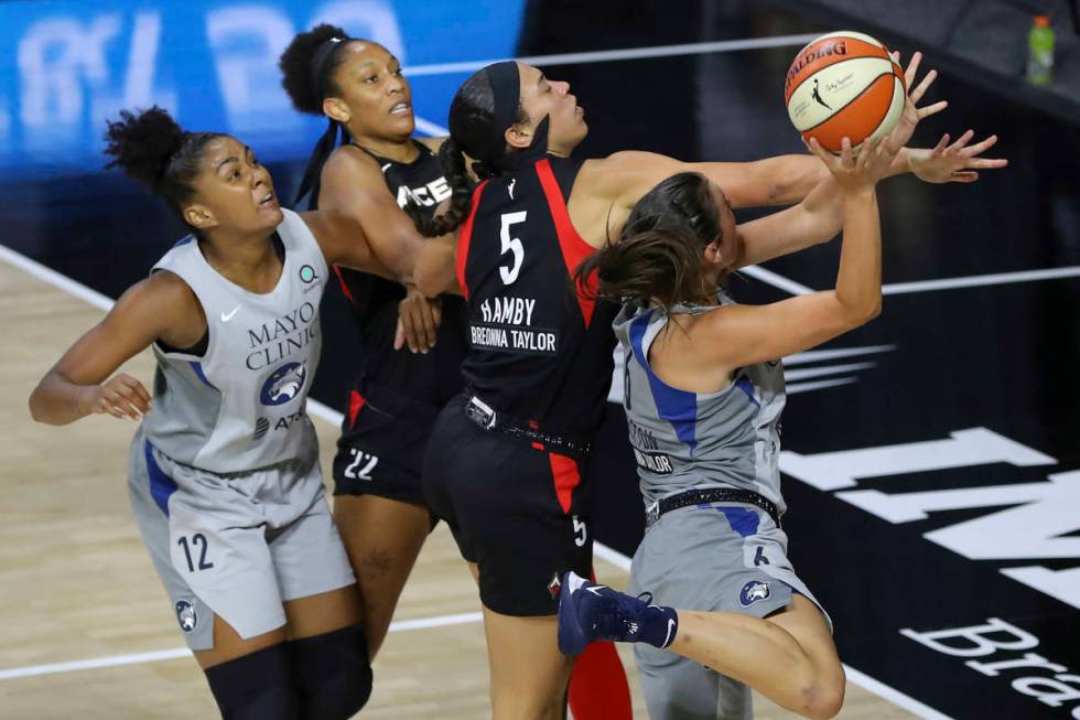 Minnesota Lynx's Bridget Carleton (6) is defended by Las Vegas Aces' Dearica Hamby as Damiris D ...