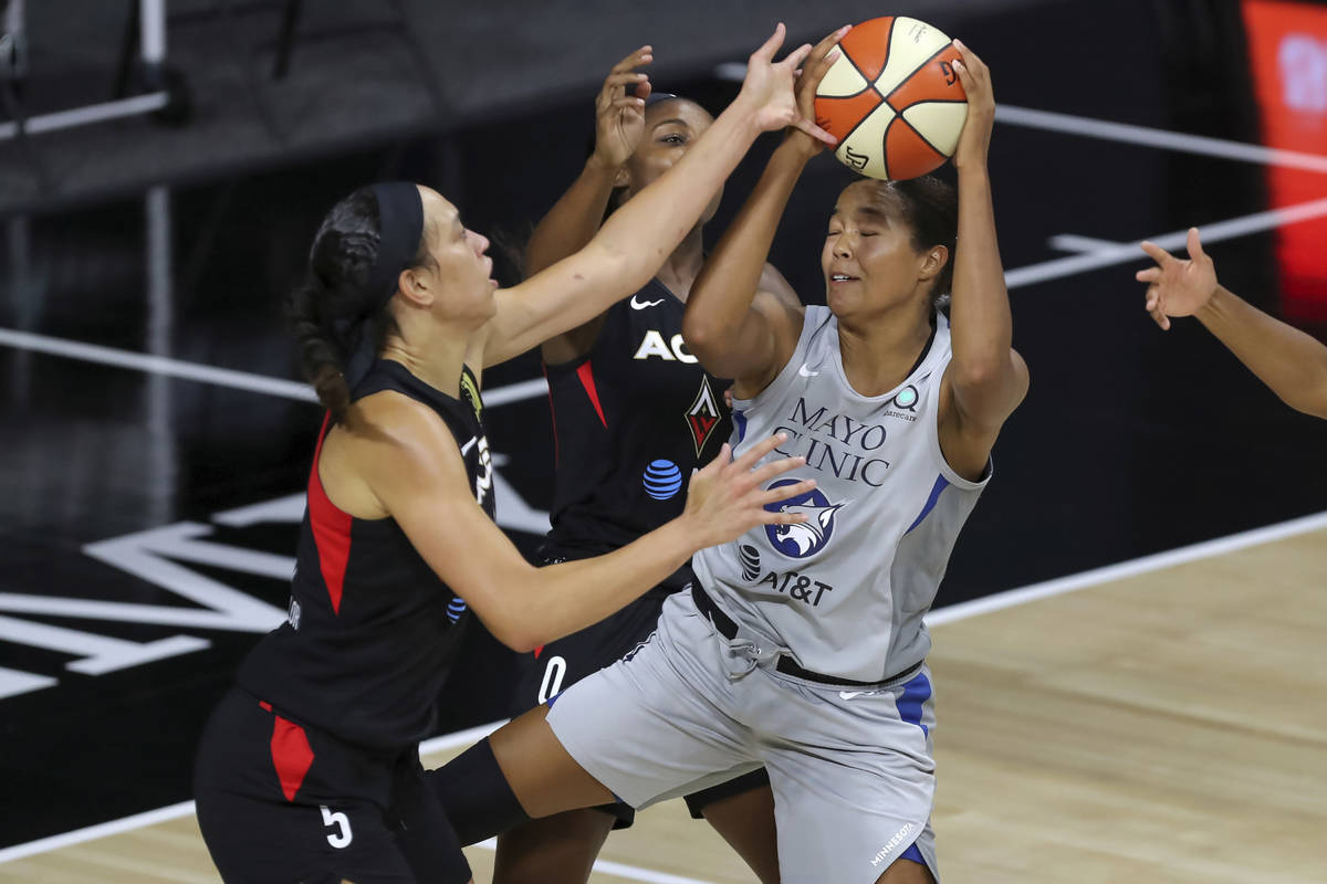 Minnesota Lynx's Napheesa Collier, right, is blocked by Las Vegas Aces' Dearica Hamby during th ...