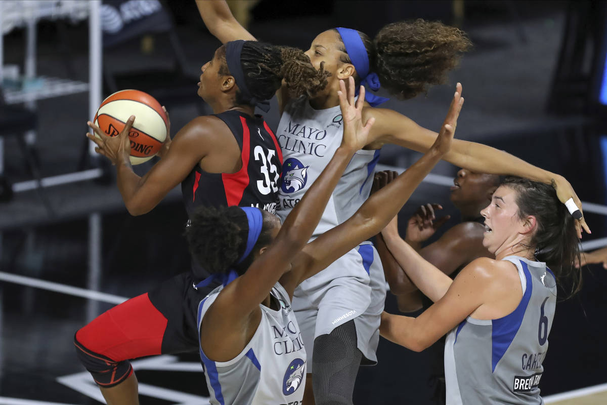 Las Vegas Aces' Angel McCoughtry (35) drives through the Minnesota Lynx defense of, from left t ...
